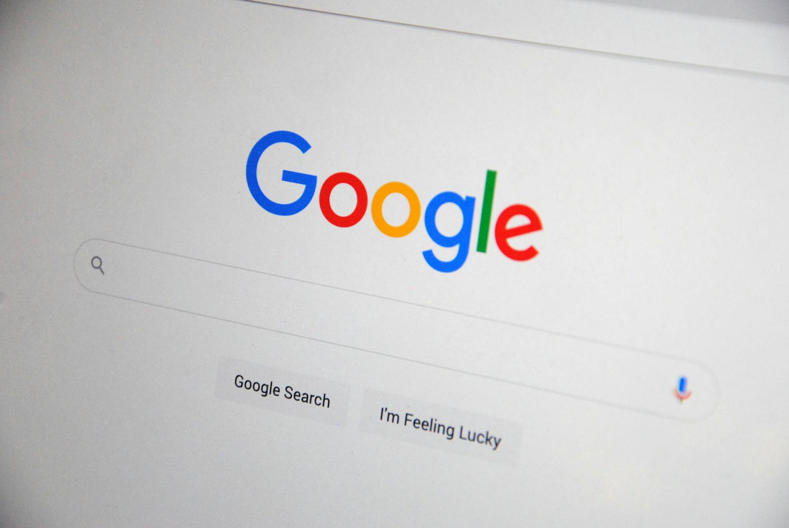 Close-up of the Google homepage on a laptop screen showing the search bar