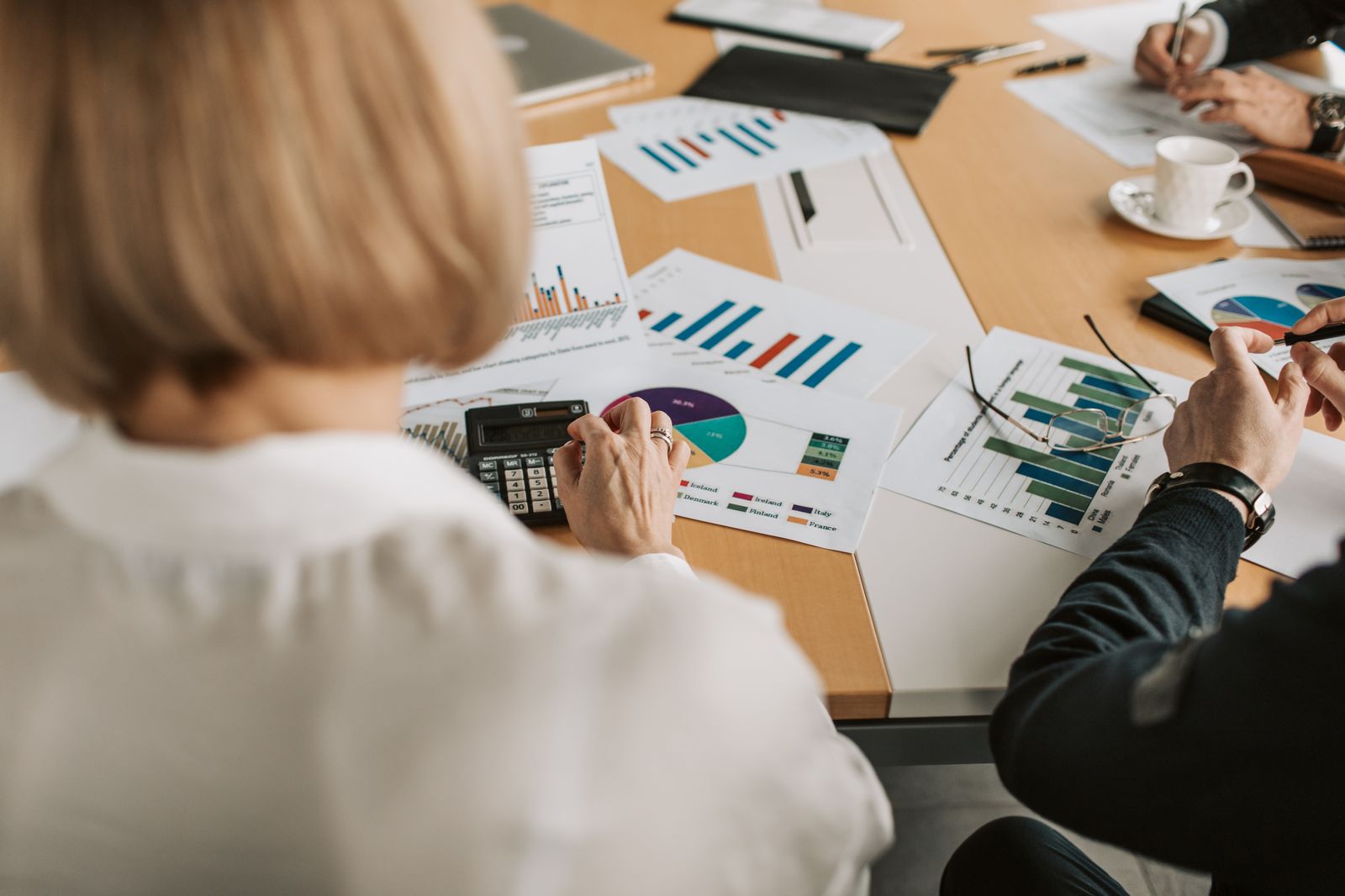 Financial professionals reviewing charts and graphs in a strategy meeting