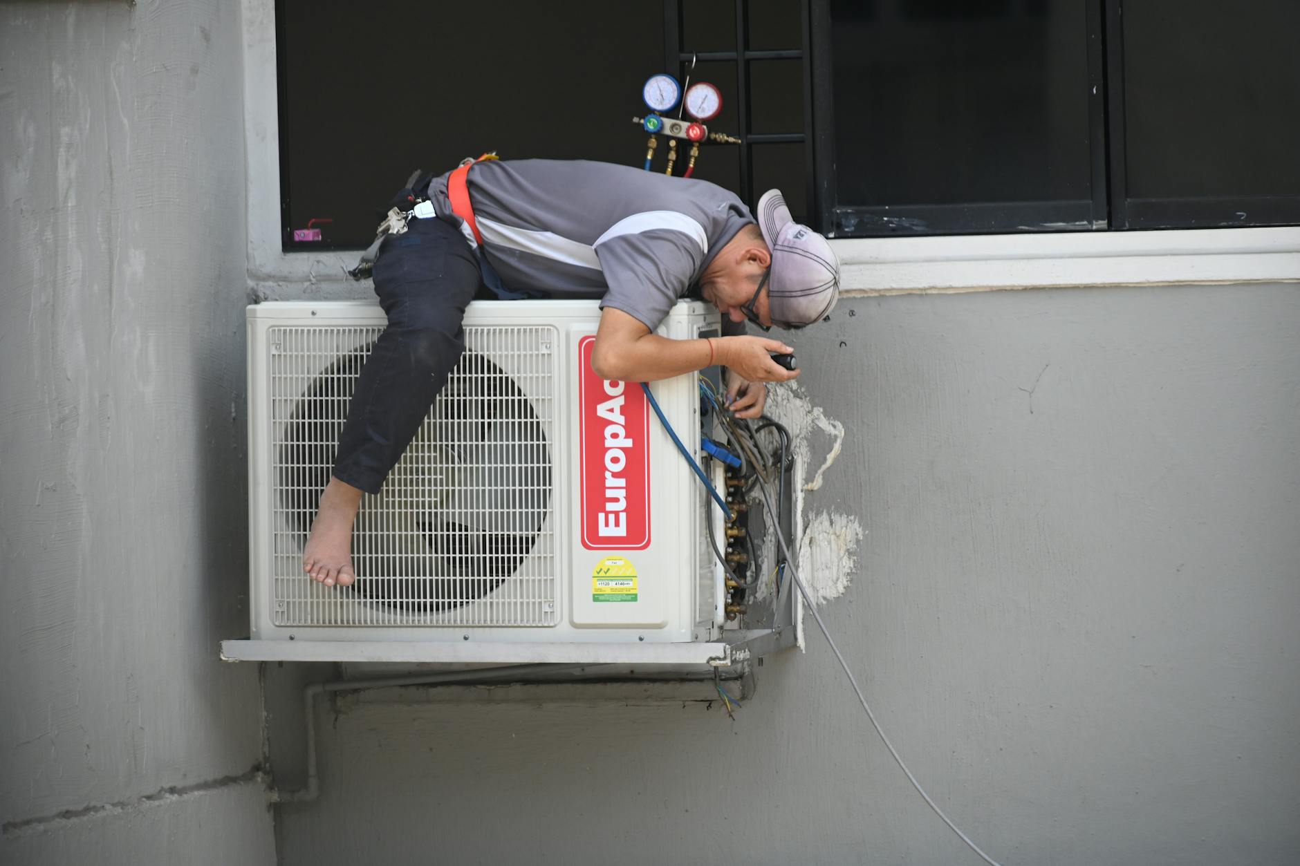 Technician servicing outdoor HVAC unit