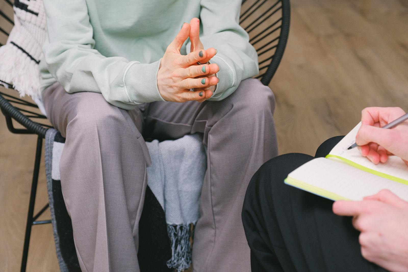 Psychotherapist taking handwritten notes during a client session