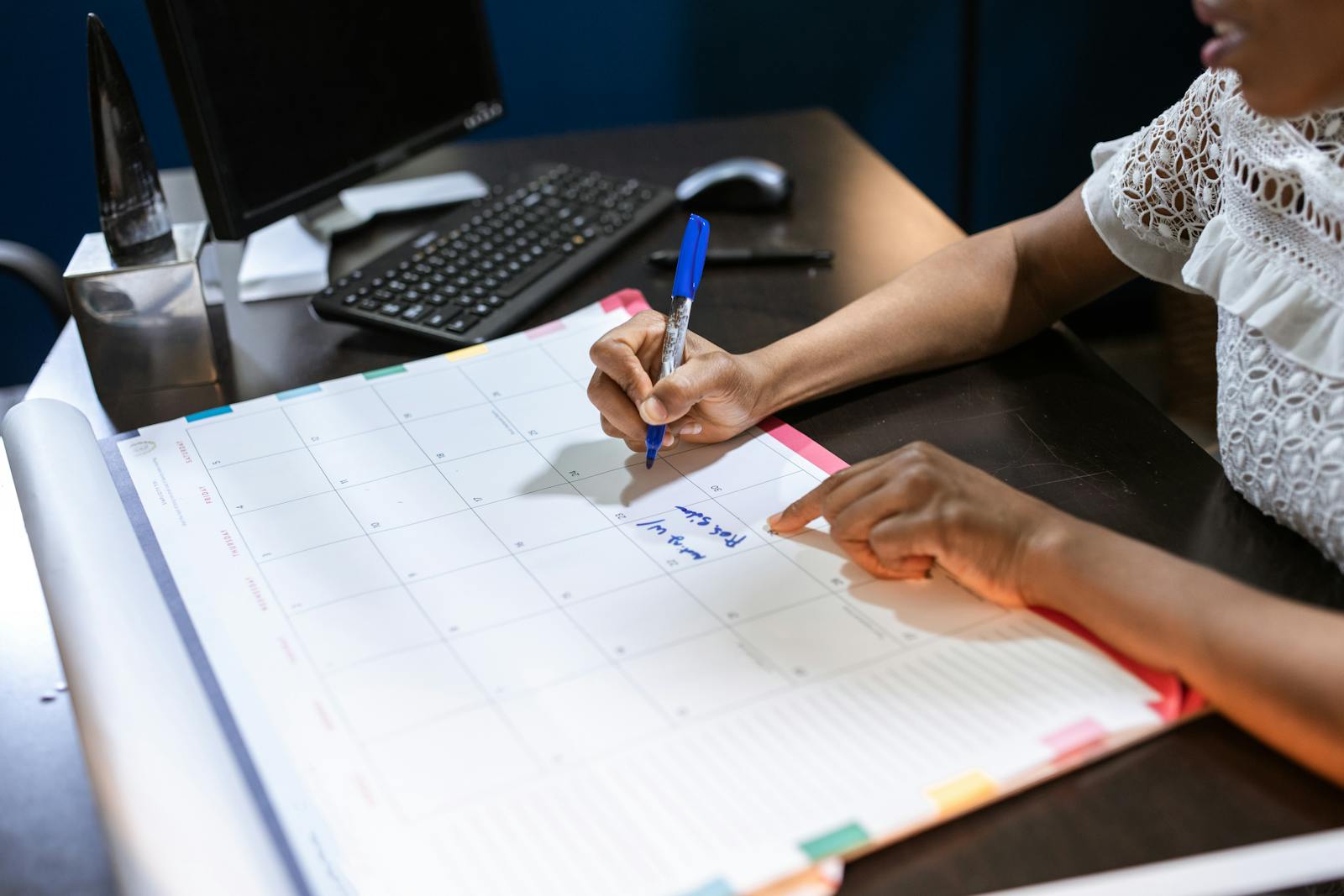 Hand writing tax planning notes on a desk calendar