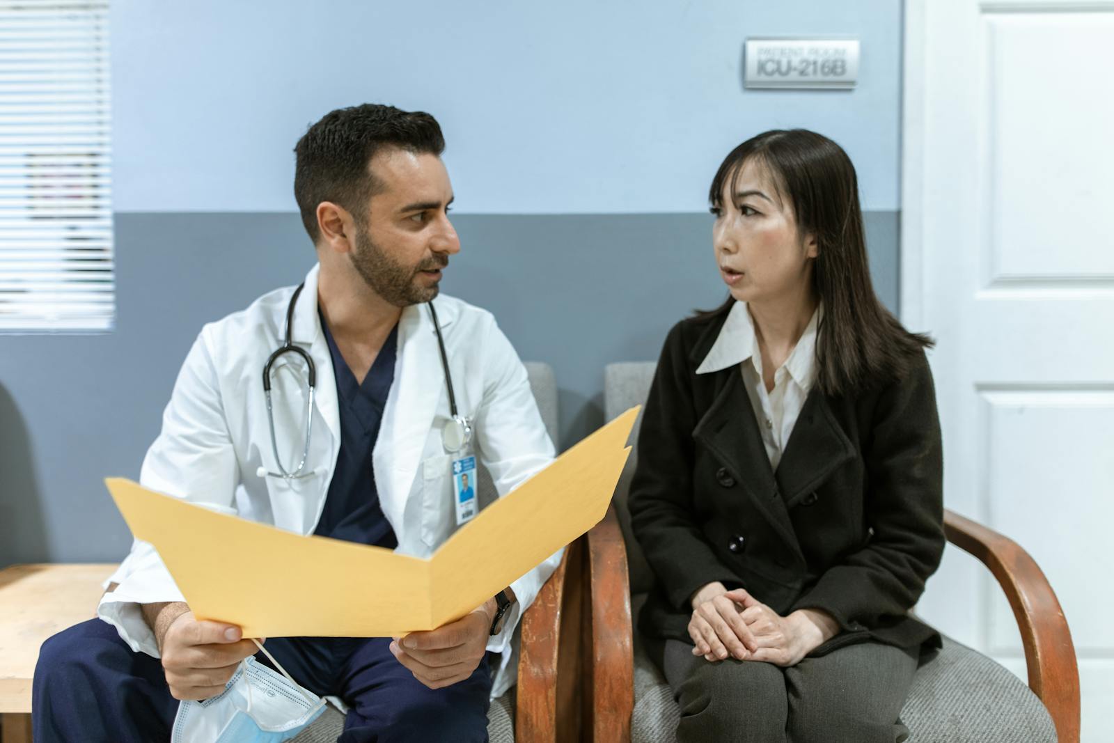 Plastic surgeon explaining a procedure to a patient during a private consultation