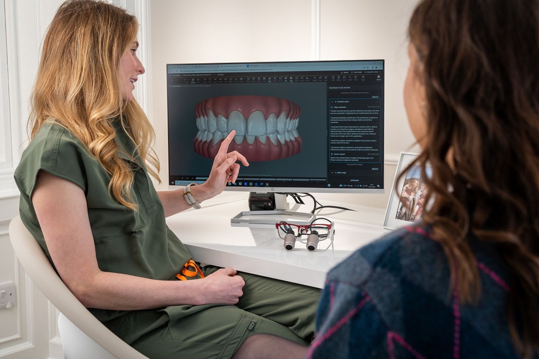 Cosmetic dentist showing a smile makeover plan using a 3D dental model