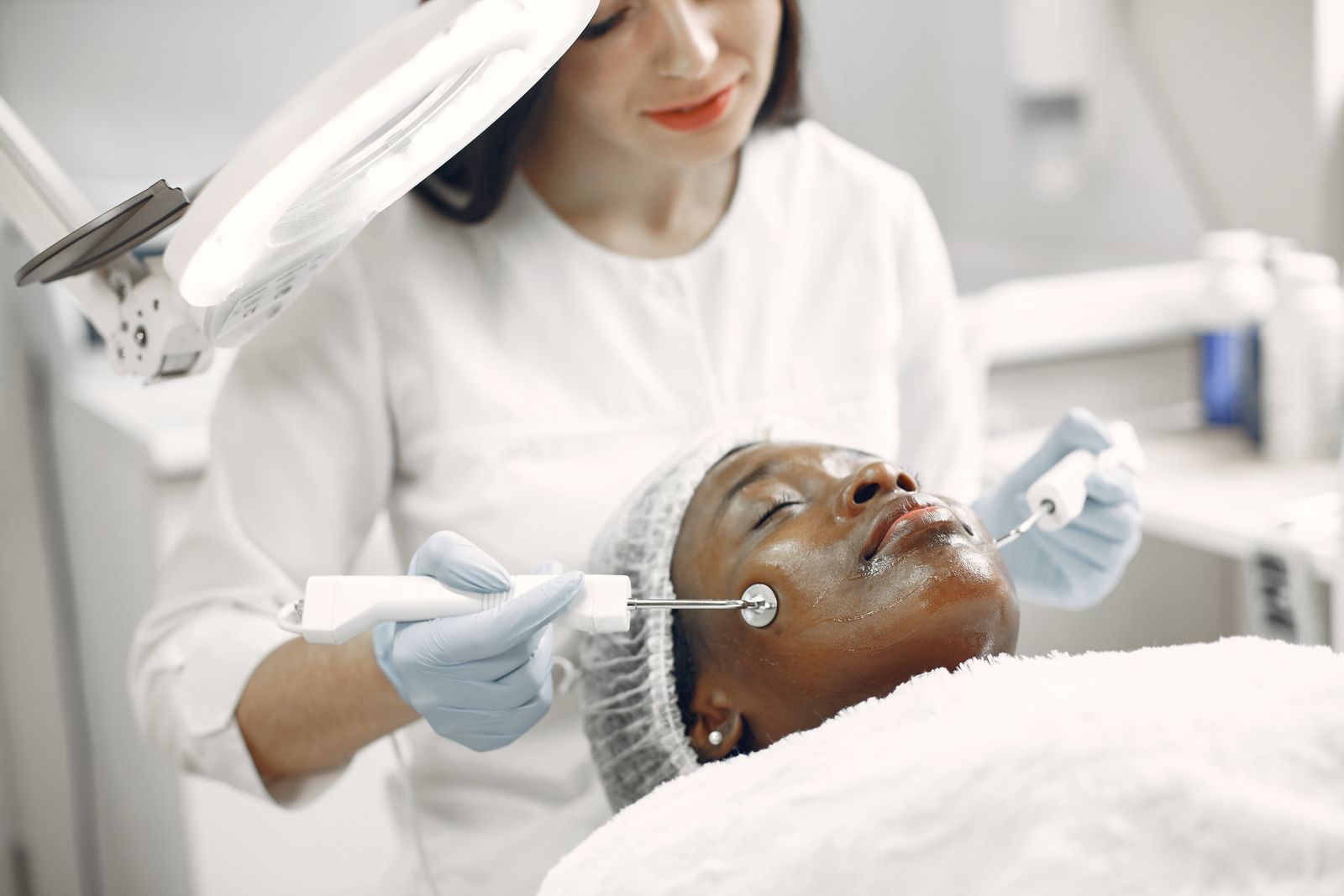 Experienced dermatologist administering professional facial treatment in modern clinical practice