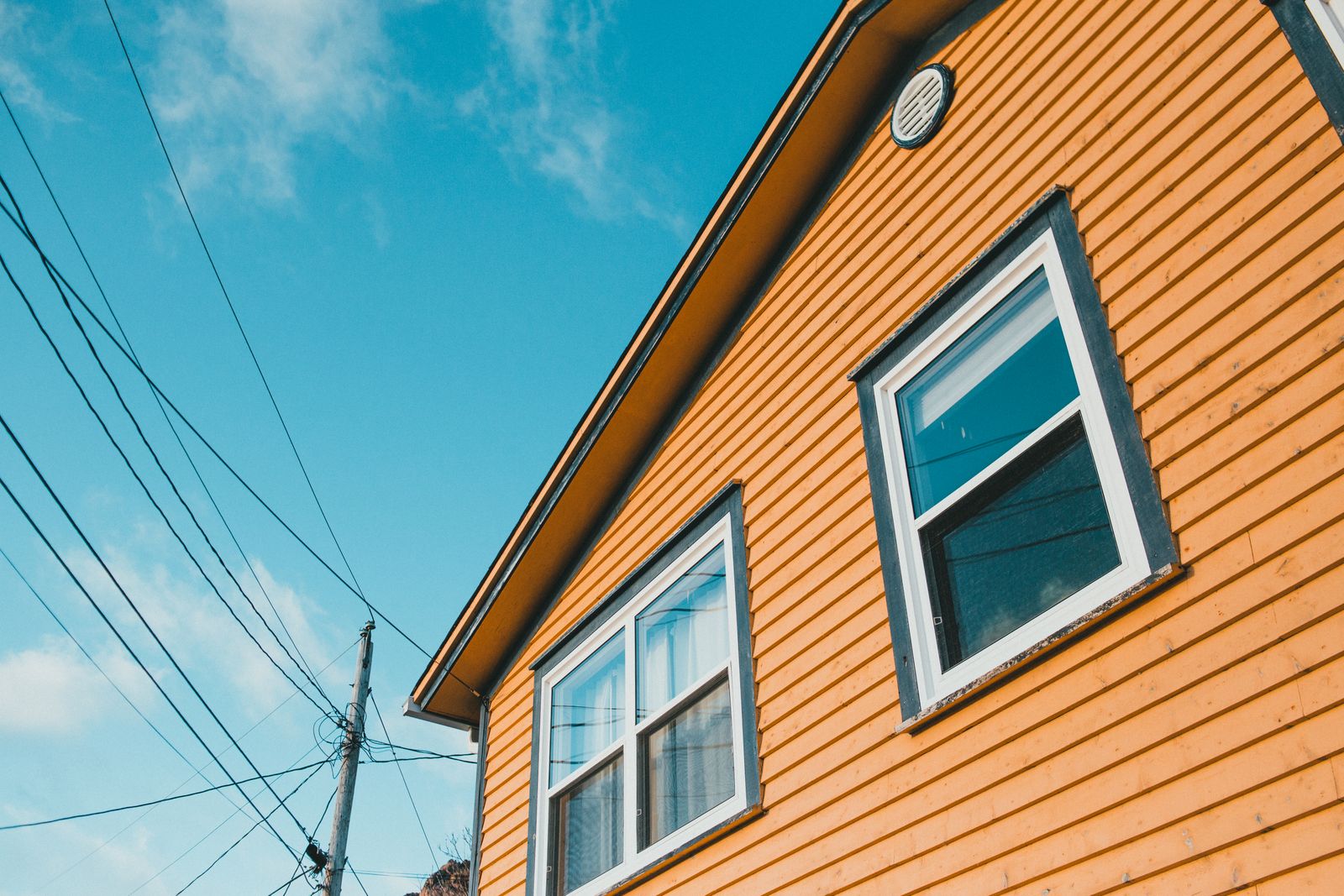 Exterior siding of a residential home that is a candidate for pressure washing and curb-appeal cleaning