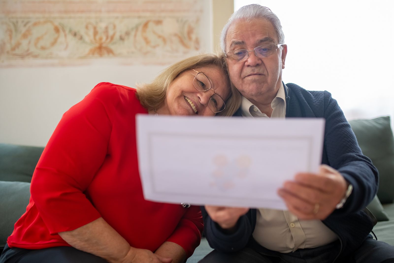 Elderly couple smiling while reviewing their estate plan together