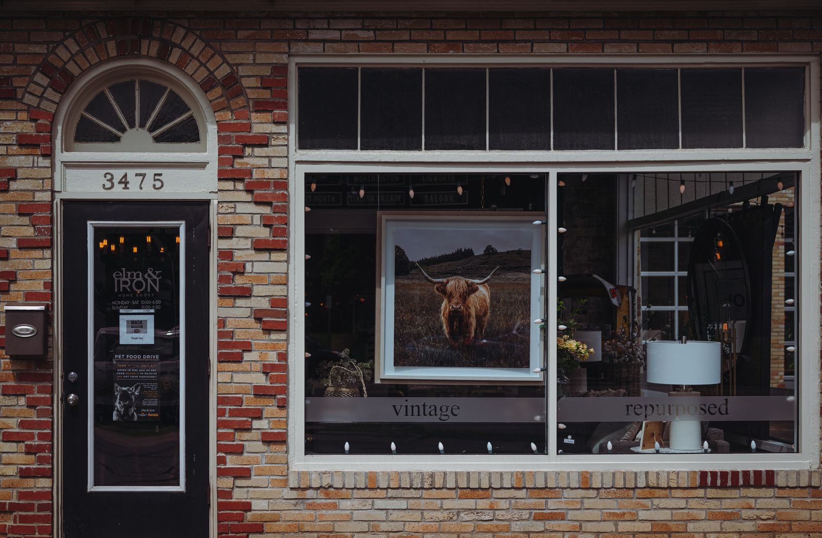 Small local vintage and repurposed home goods storefront with brick facade representing hyperlocal small business