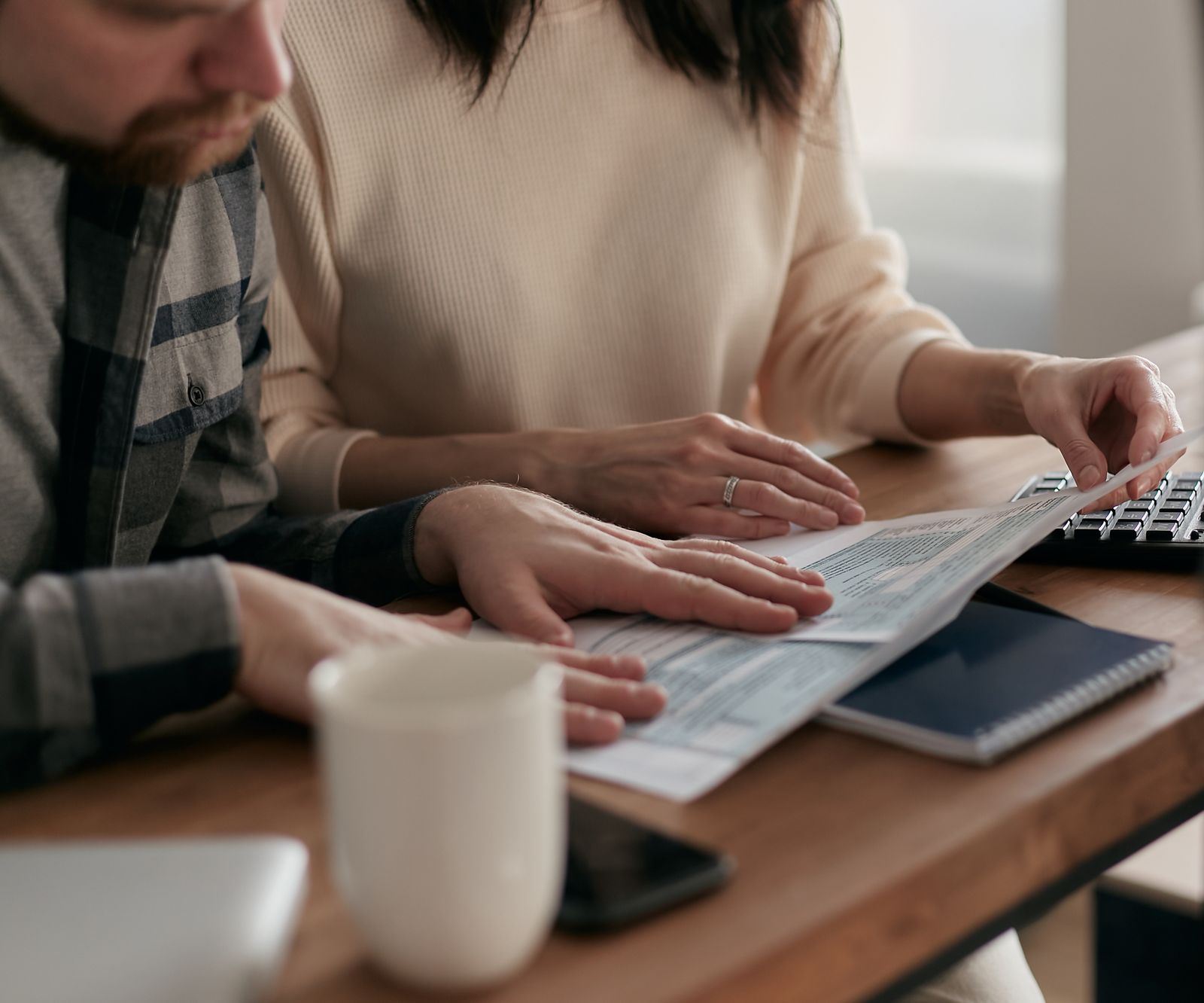 Couple reviewing financial and estate planning documents at home
