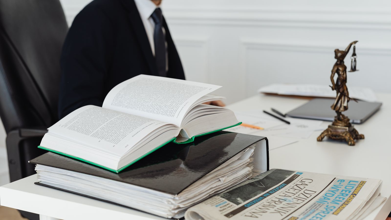 Attorney reviewing legal research books and case documents at a desk