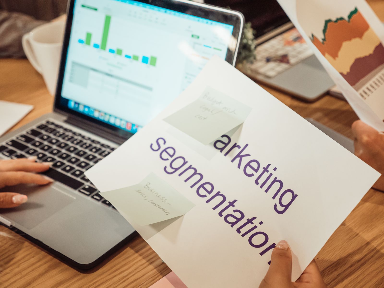 Small business marketing analytics review with charts on laptop showing organic growth