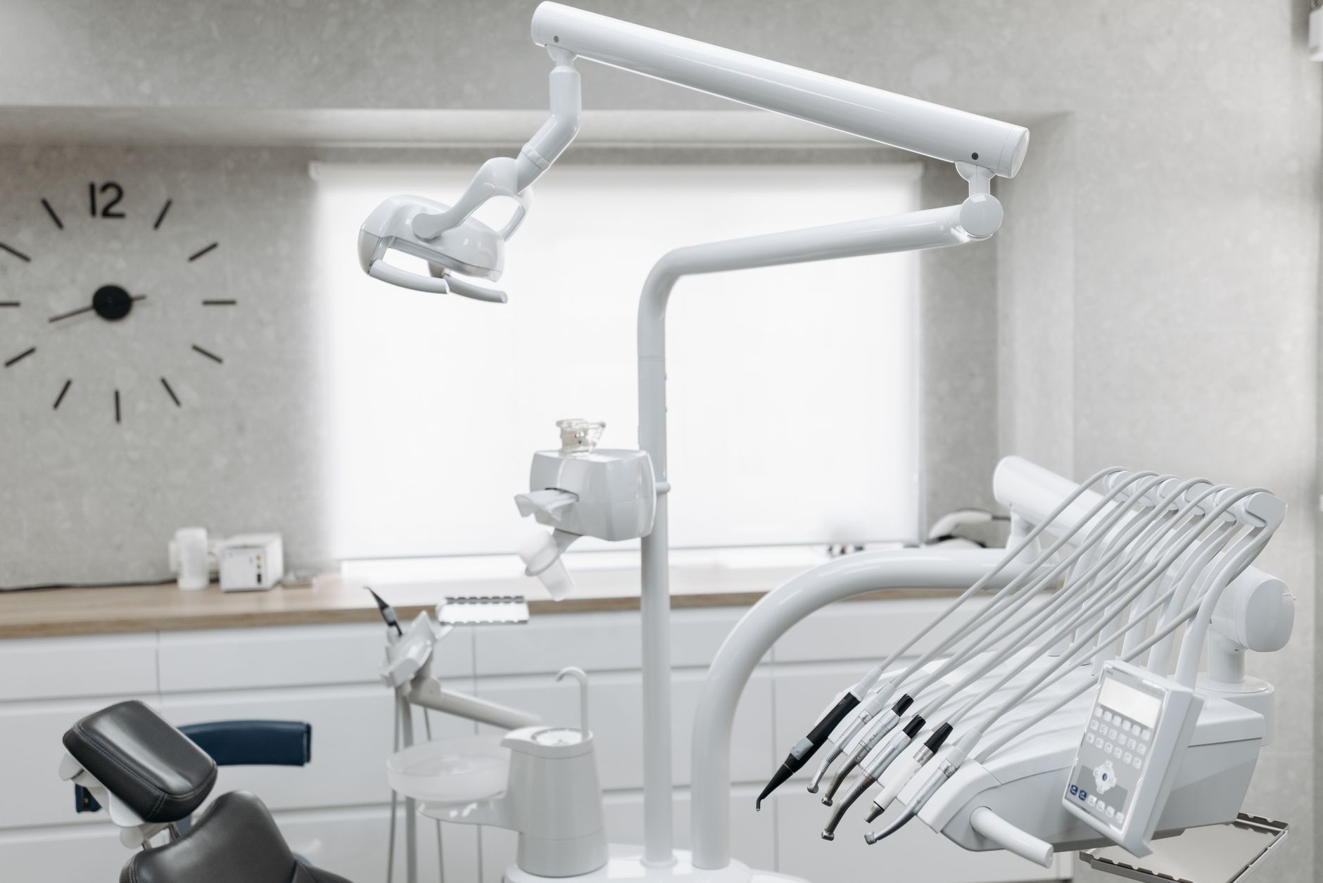 Modern orthodontic clinic interior with treatment chair and overhead light