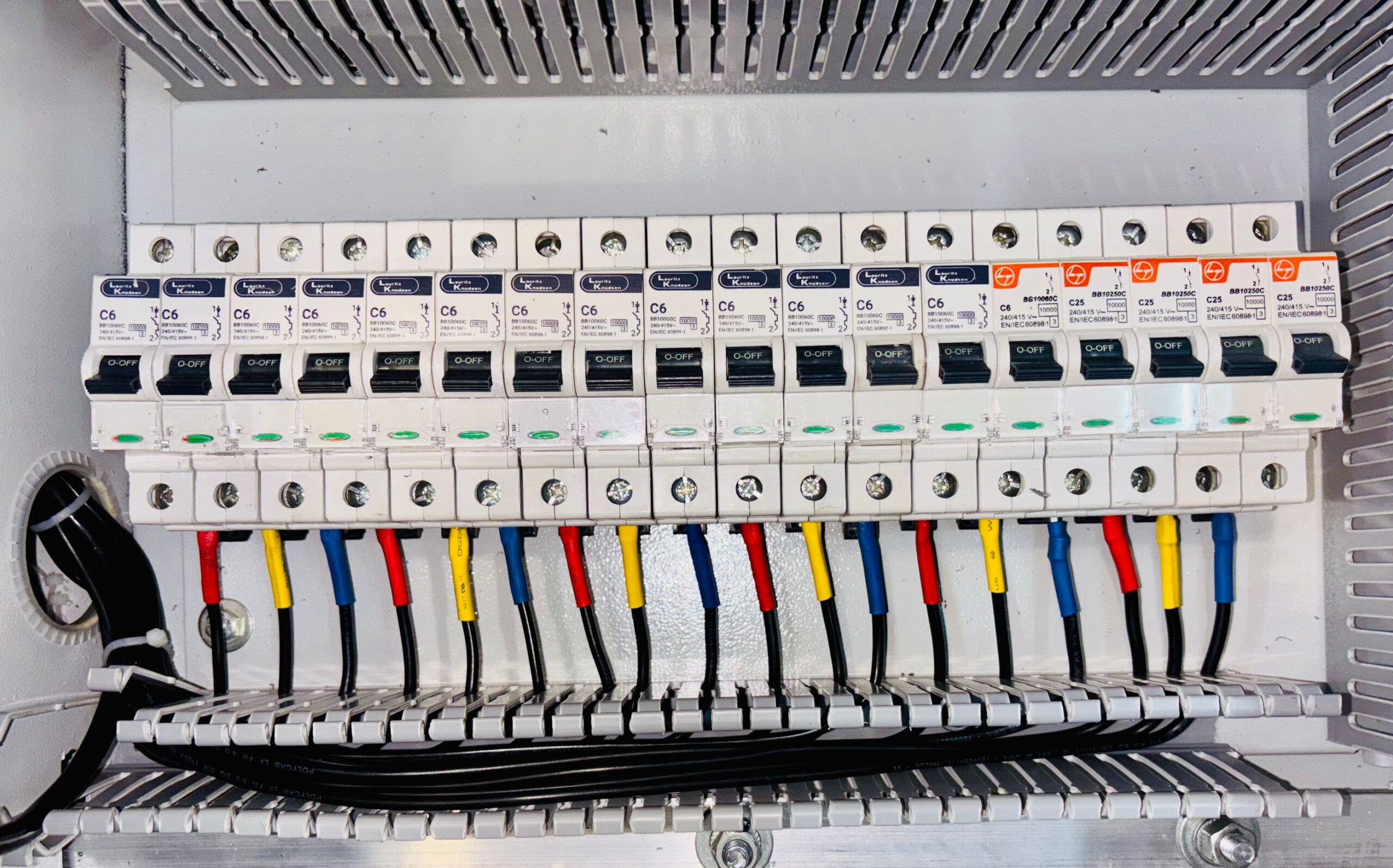 Organized circuit breaker panel showing color-coded electrical wires neatly arranged