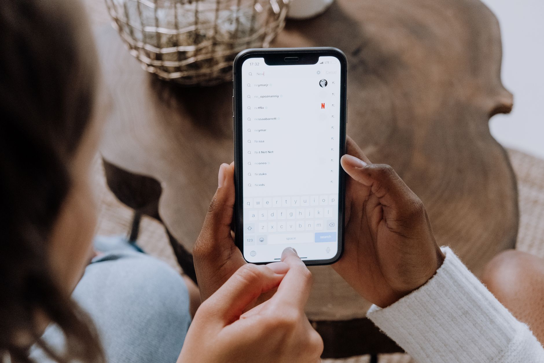 Person holding a smartphone searching for a local dentist