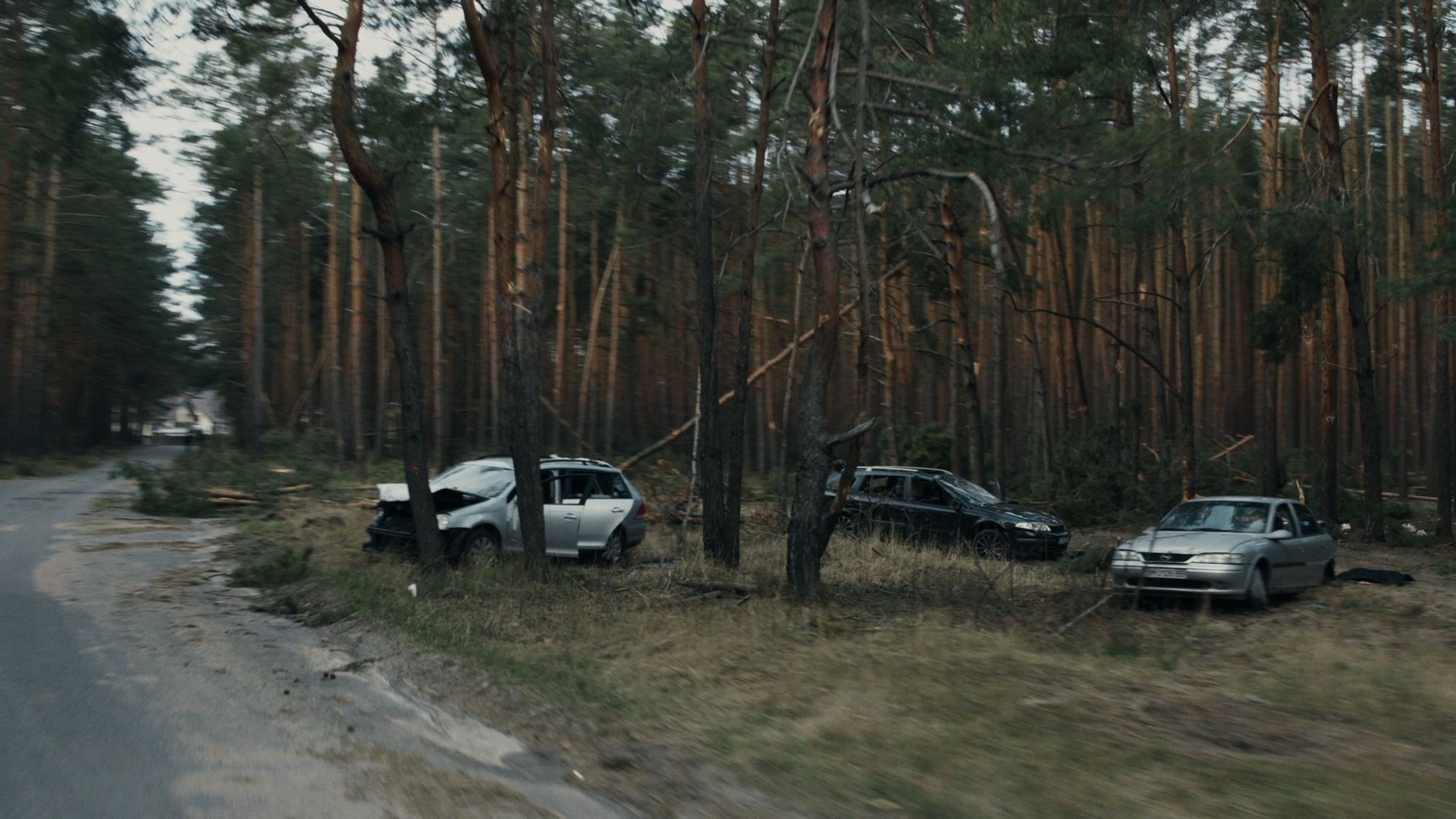 The aftermath of a car accident showing damaged vehicles off the road, the moment people first start searching for legal help