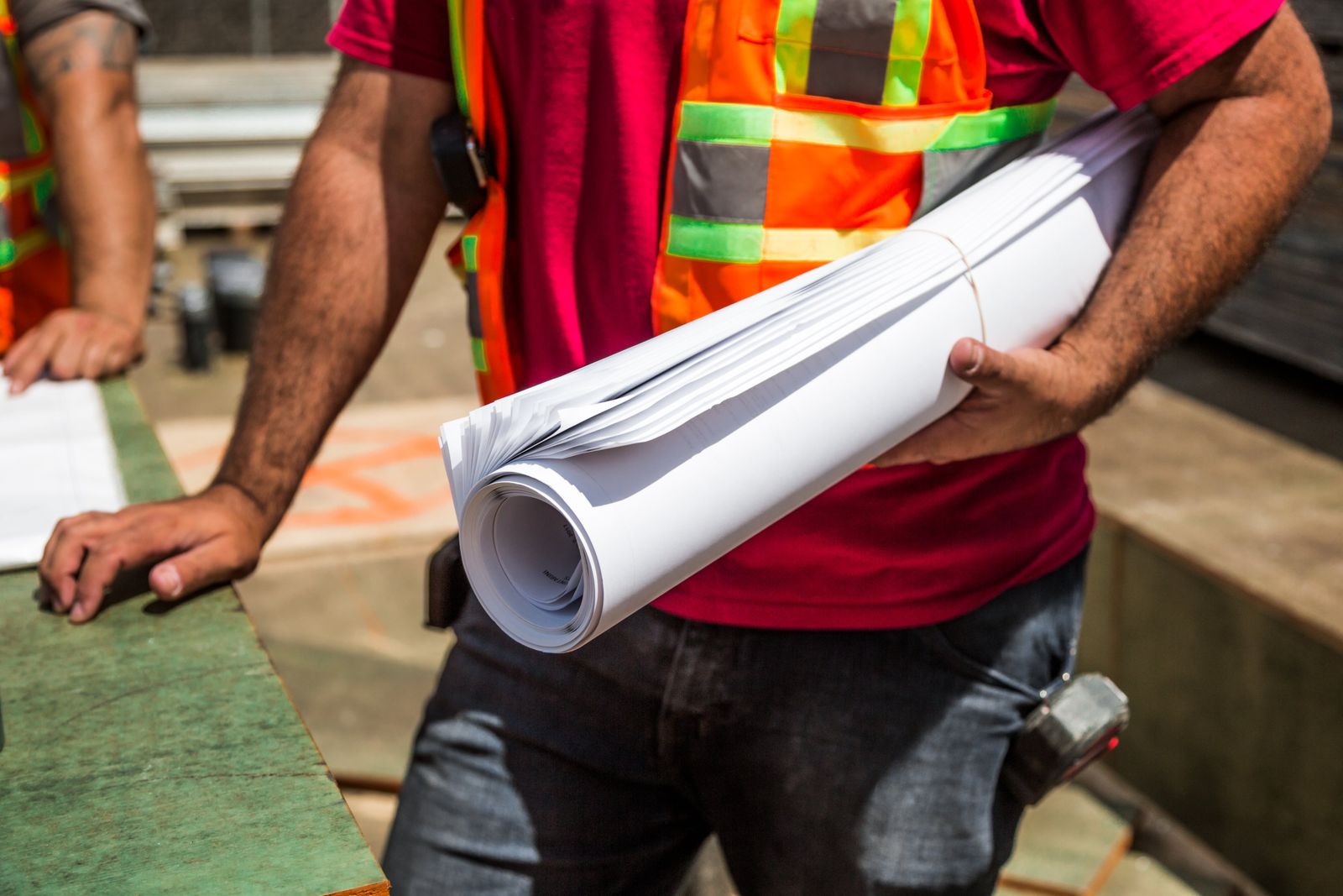 Construction team reviewing pool blueprints on site — content planning works the same way