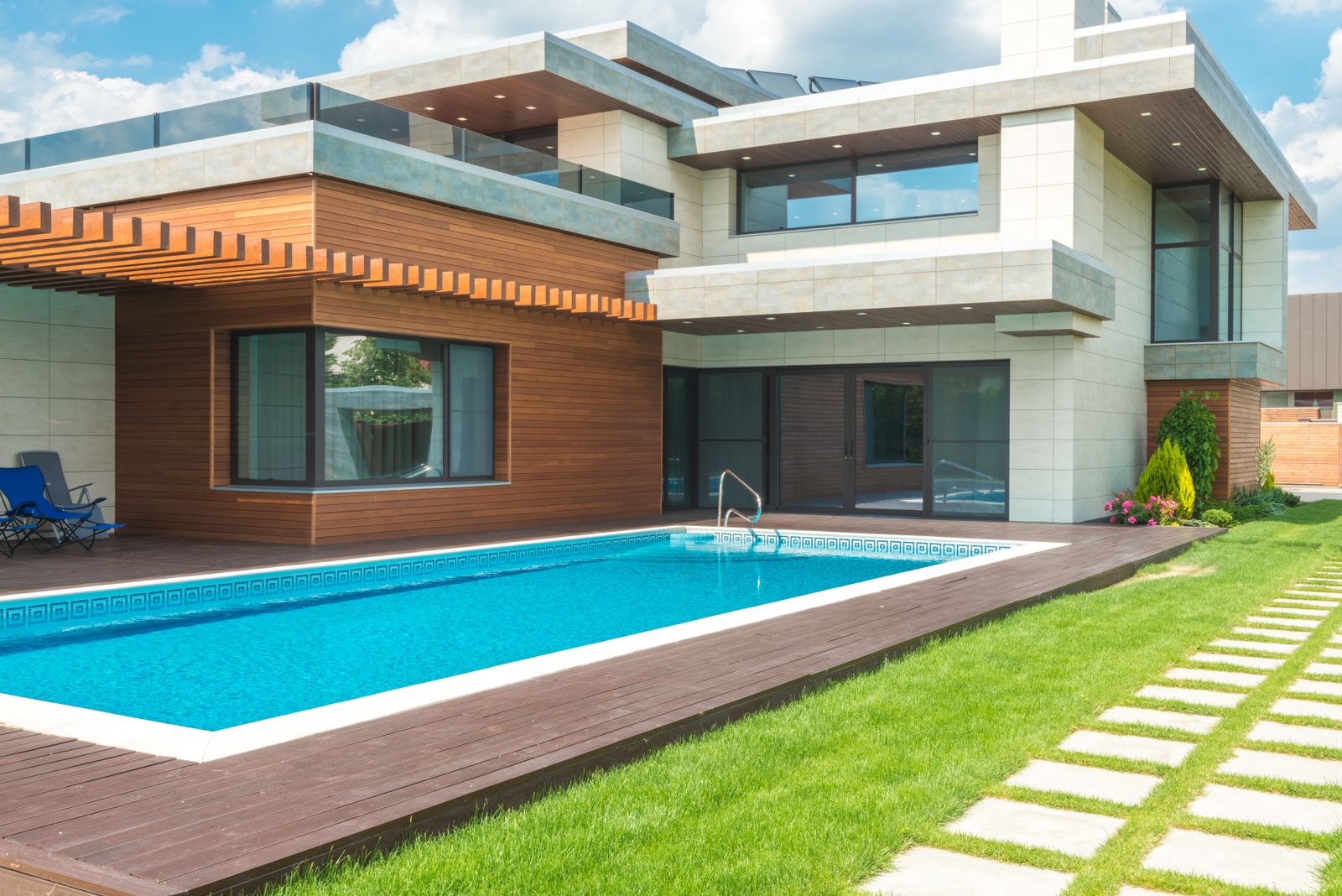 Modern backyard inground pool behind a contemporary home — the kind of $60K build SEO content can pull from Google