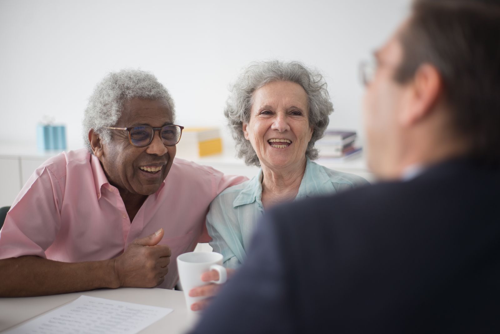 Senior couple consulting with financial advisor in office