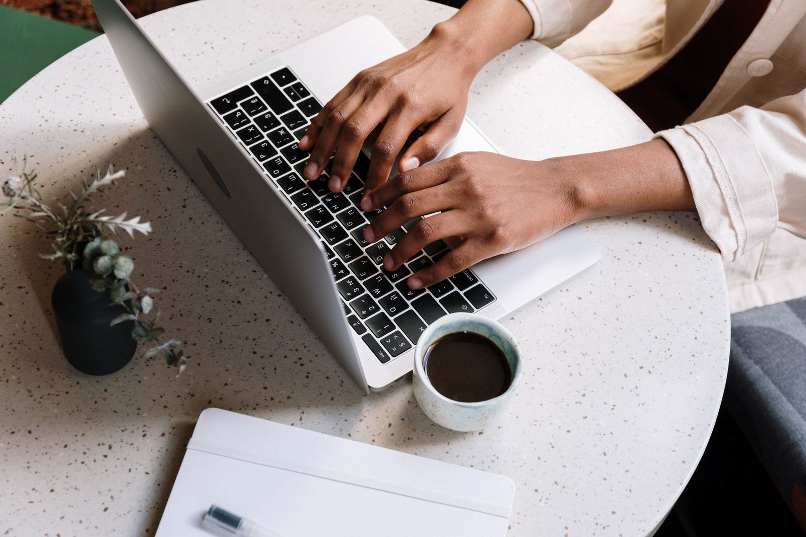 Advisor writing blog content on a laptop at a quiet workspace