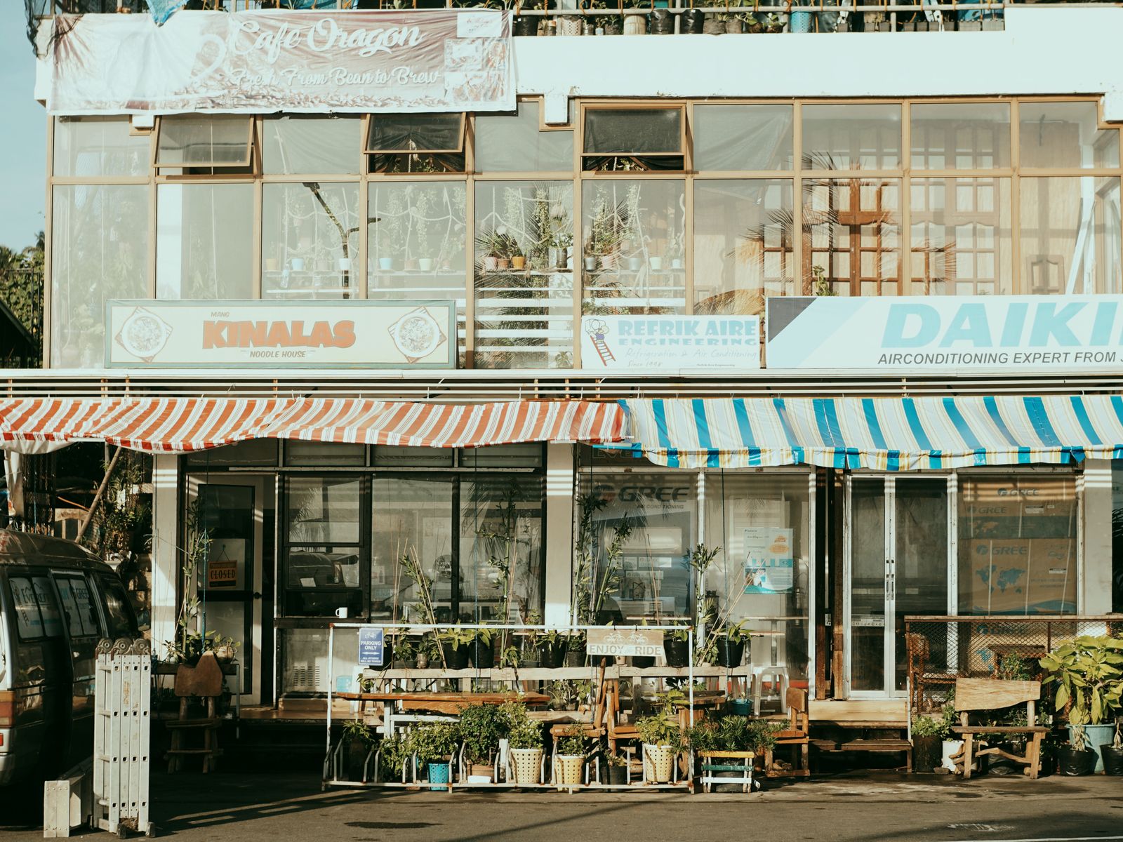 Row of local small business storefronts on a sunny street