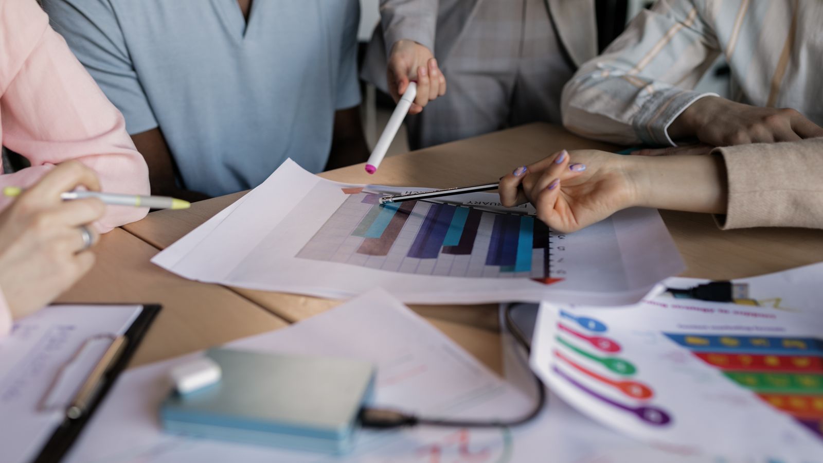 Marketing team reviewing performance charts during strategy meeting
