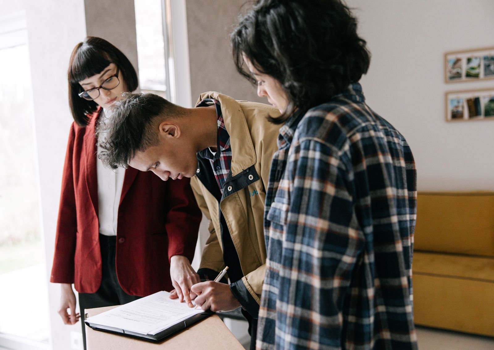 Homebuyers signing mortgage loan documents with a broker
