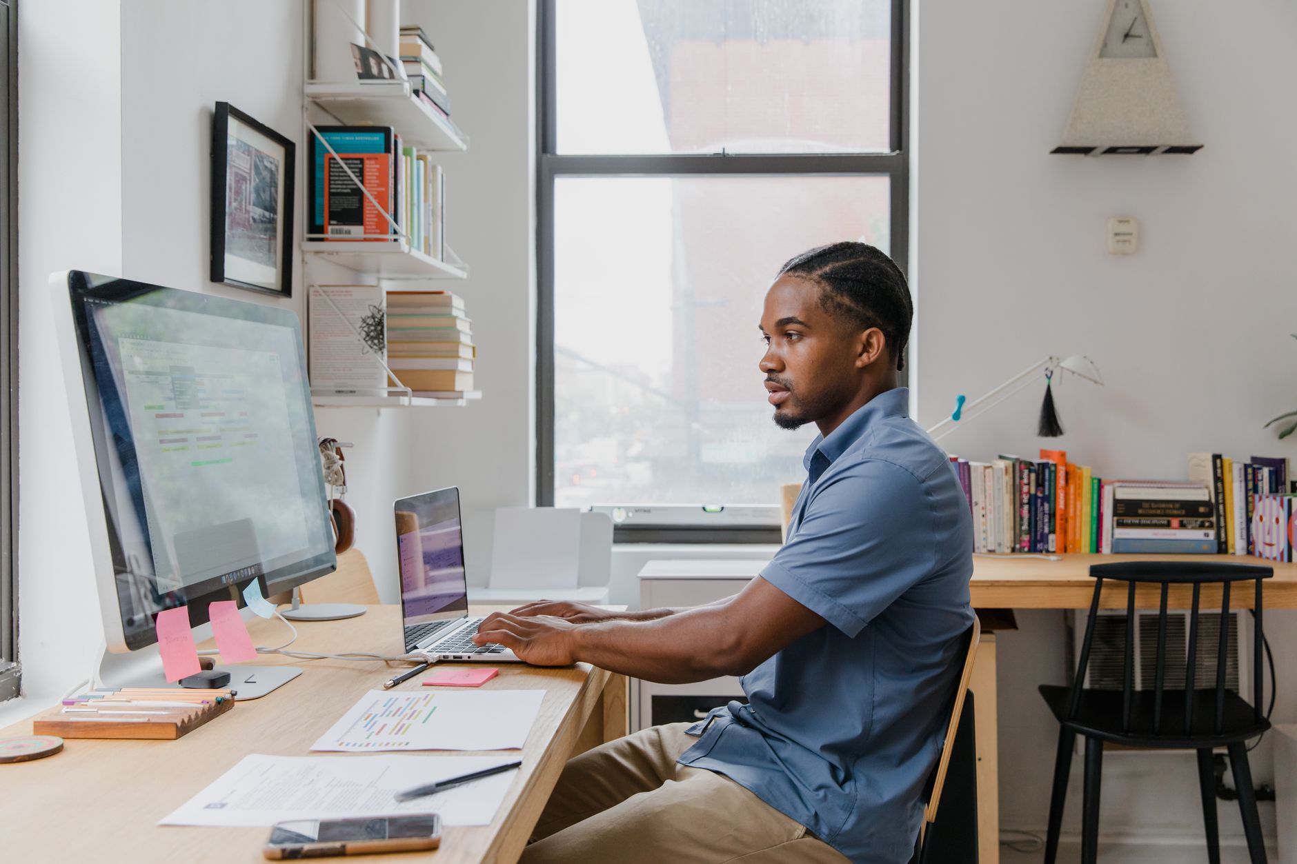 Business owner working at laptop in home office reviewing SEO performance