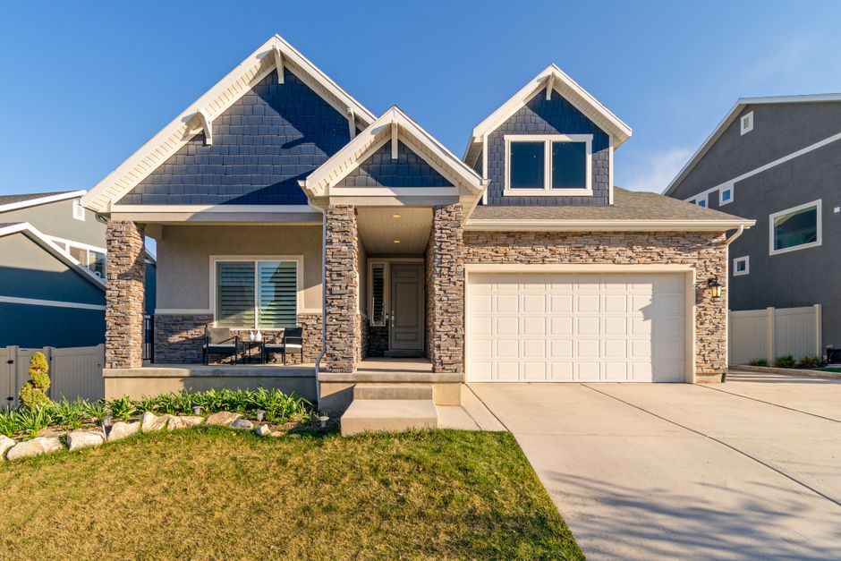 Modern suburban home with stone facade and large roof suitable for solar panel installation