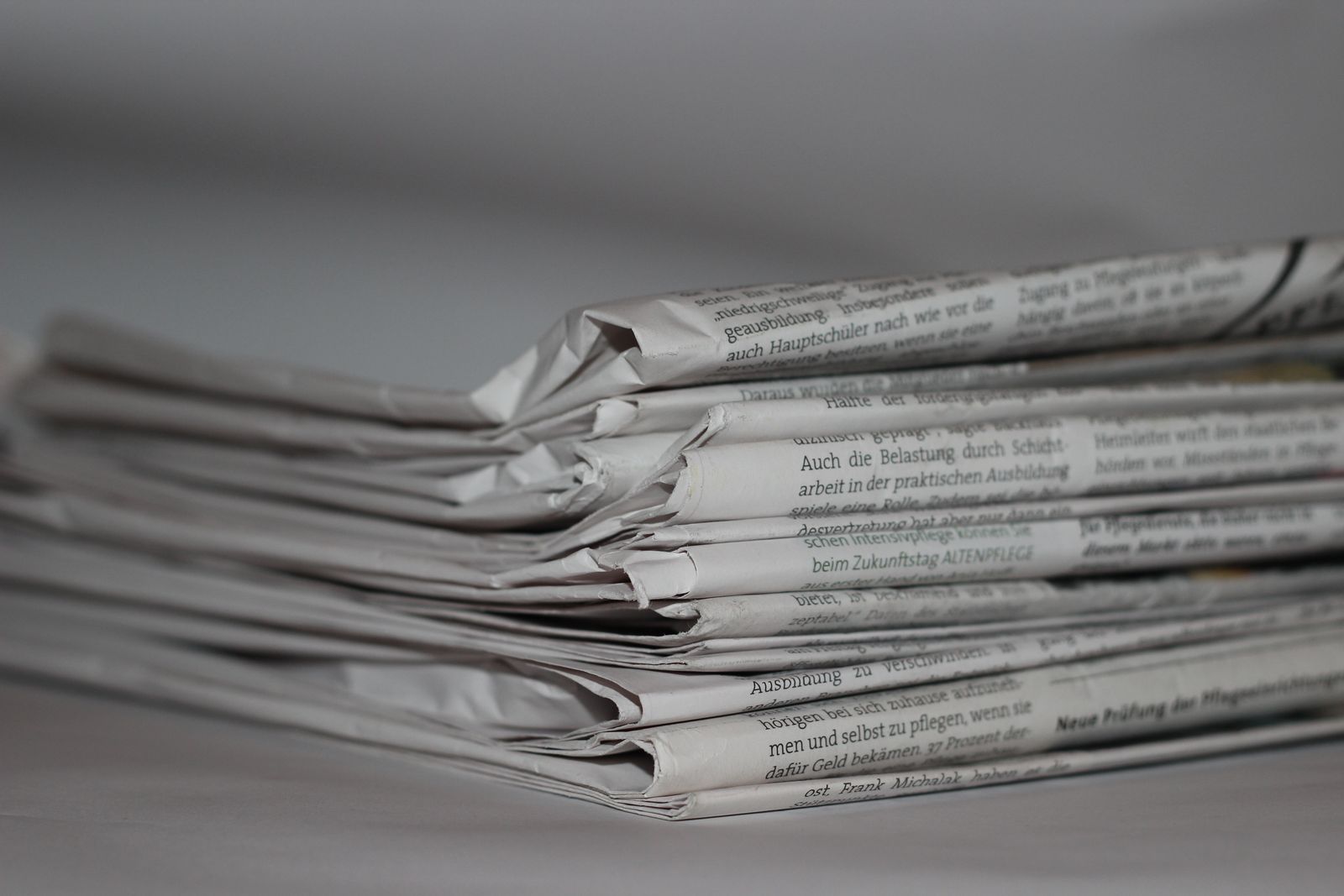 Stack of newspapers representing trending news content that ages fast