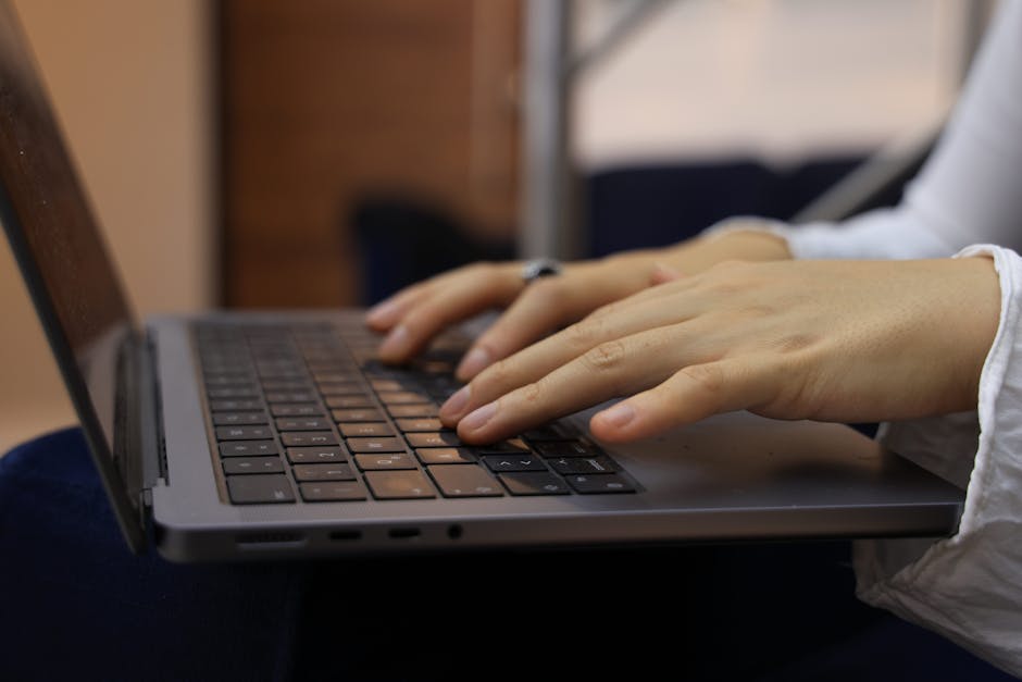 Hands typing on a laptop, drafting an SEO blog post for a local solar business