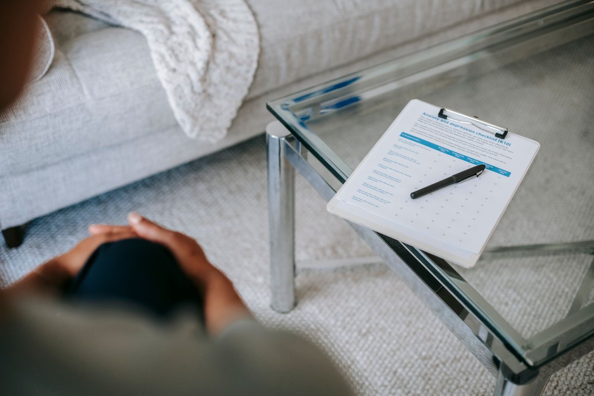 anxiety and depression checklist on clipboard during therapy intake session