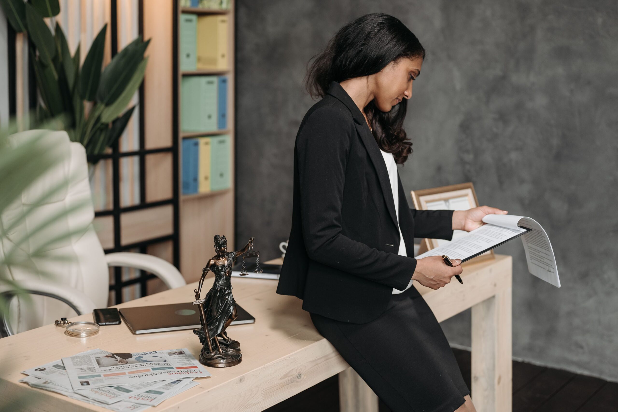 Attorney in a business suit reviewing legal immigration documents at a desk