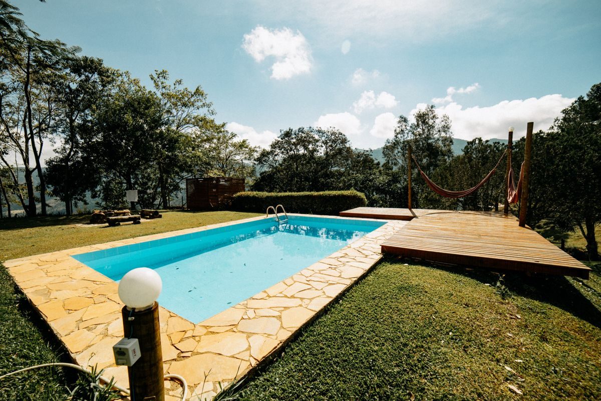 Backyard swimming pool with stone deck and hammock