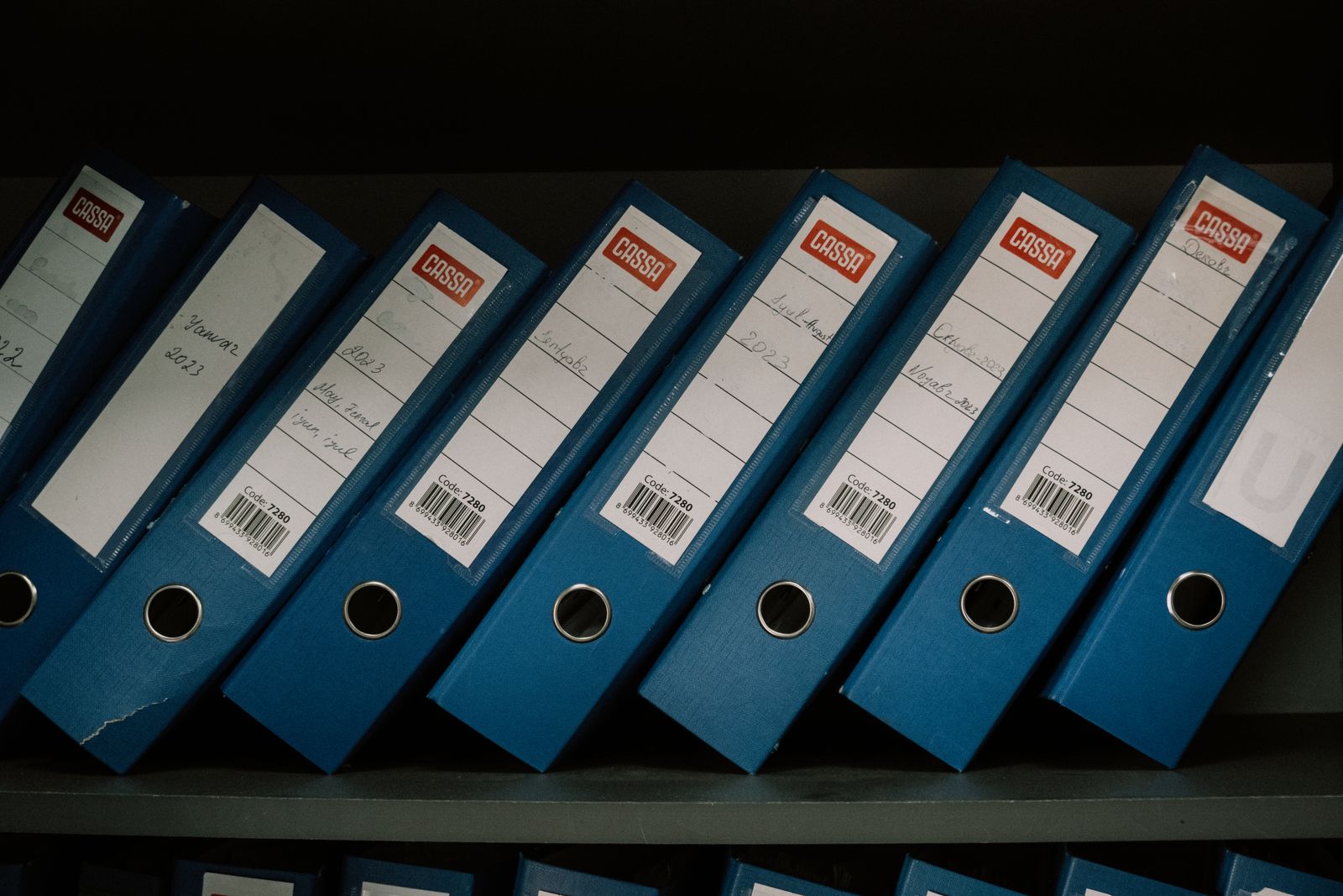 Row of labeled binders representing content organized into pillar page topic clusters
