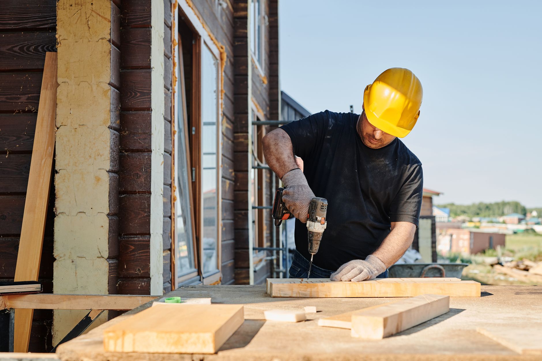 A contractor using a power drill during an installation, representing hands-on garage door work
