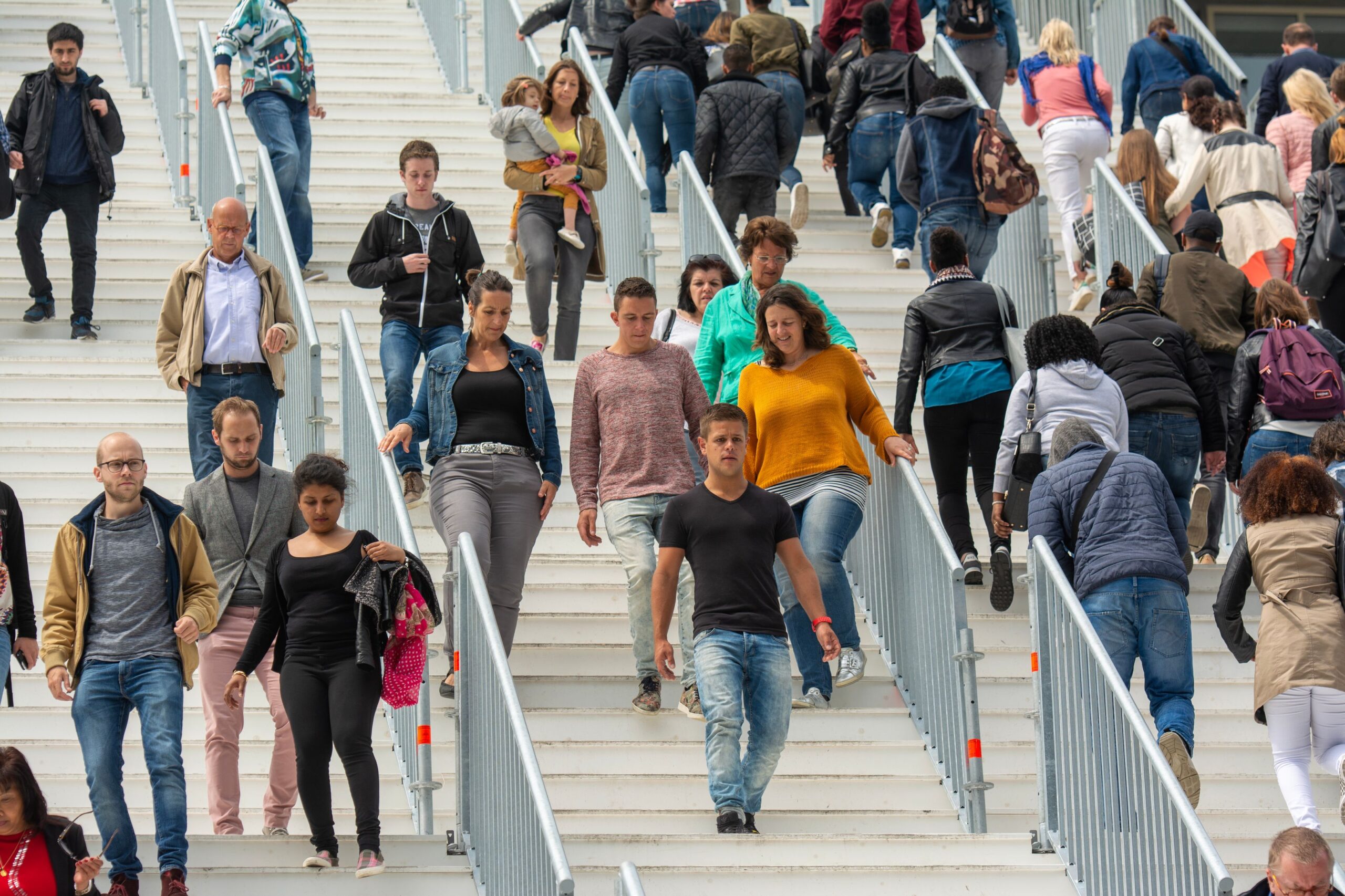 A diverse crowd of people walking through a busy urban area representing prospective immigration clients
