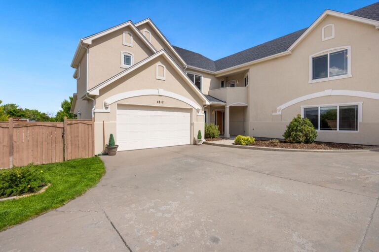 Modern suburban home exterior with a double garage door and driveway