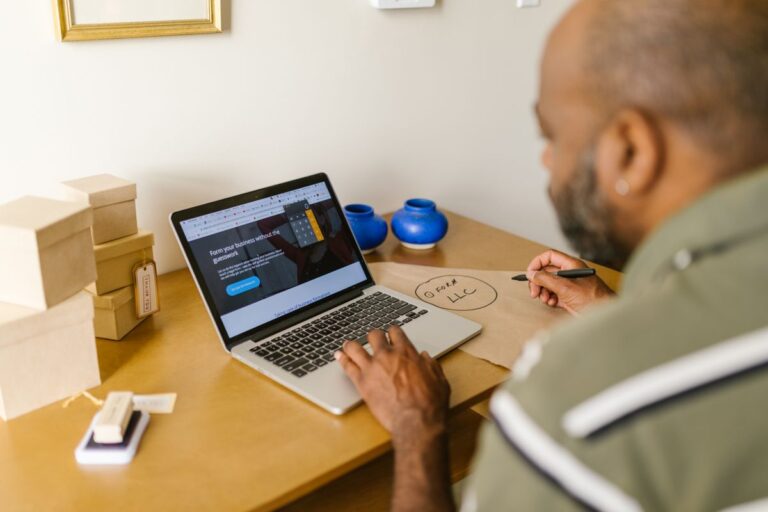 Small business owner using laptop to review Google E-E-A-T and website quality signals
