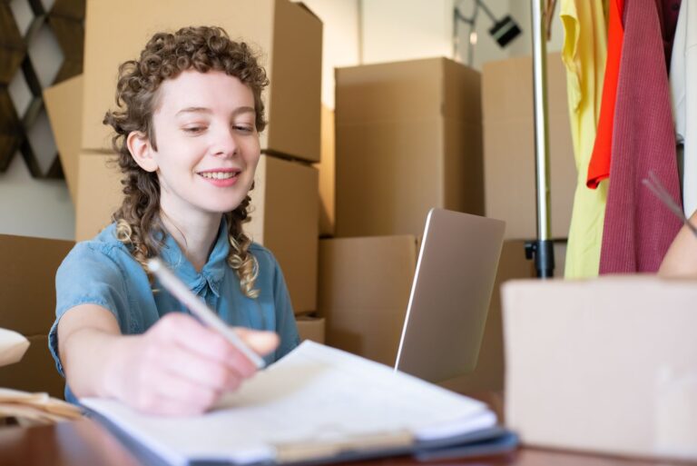 Small business owner reviewing keyword notes at her laptop in a home office