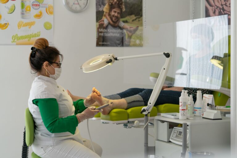 Podiatrist treating a patient's foot in a modern foot-care clinic