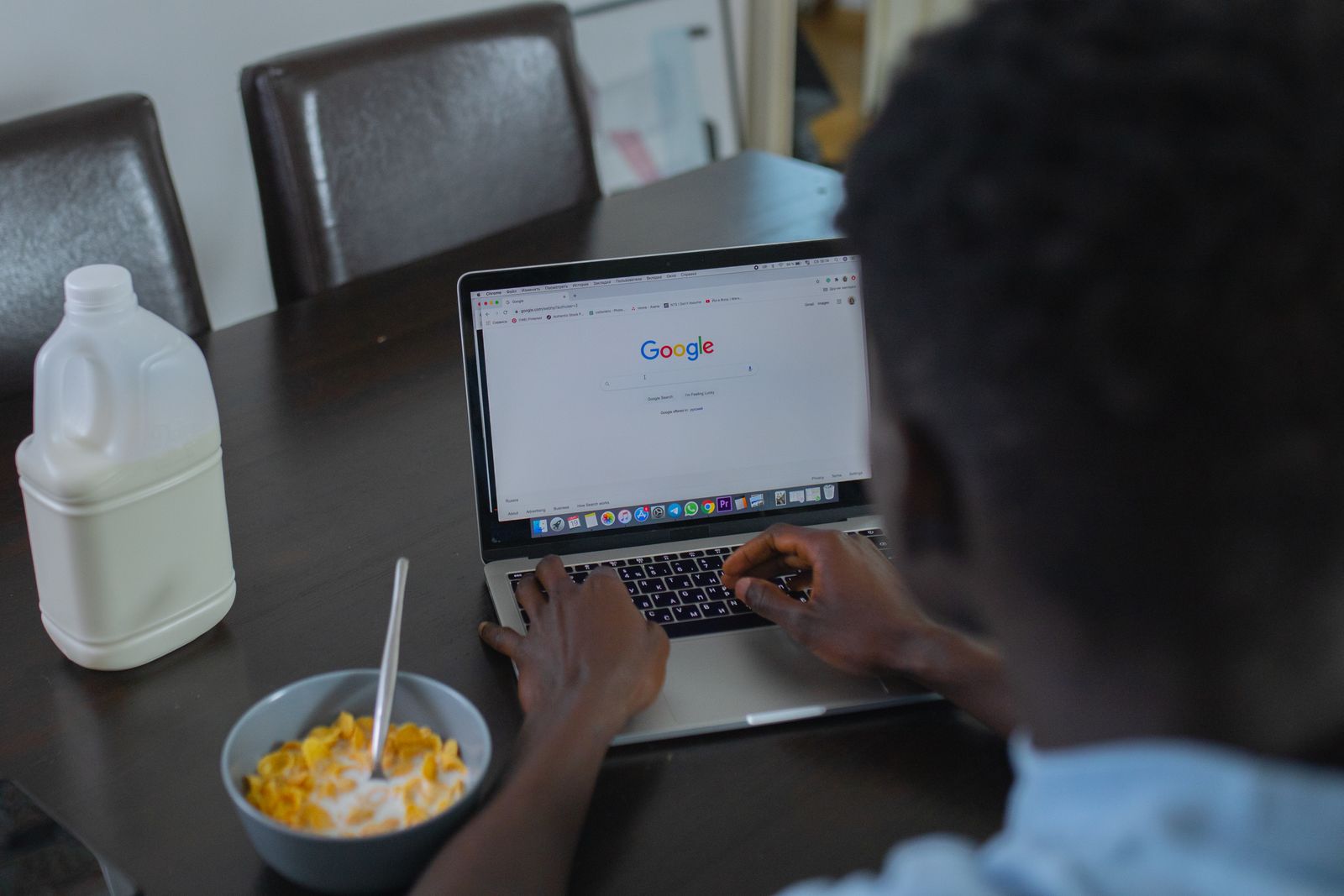 Homeowner searching Google on a laptop to find a local electrician