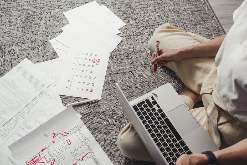 A business owner mapping out a publishing calendar next to a laptop
