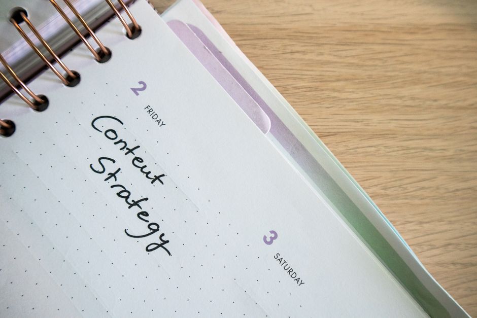 A notebook page planning out a content strategy for the month