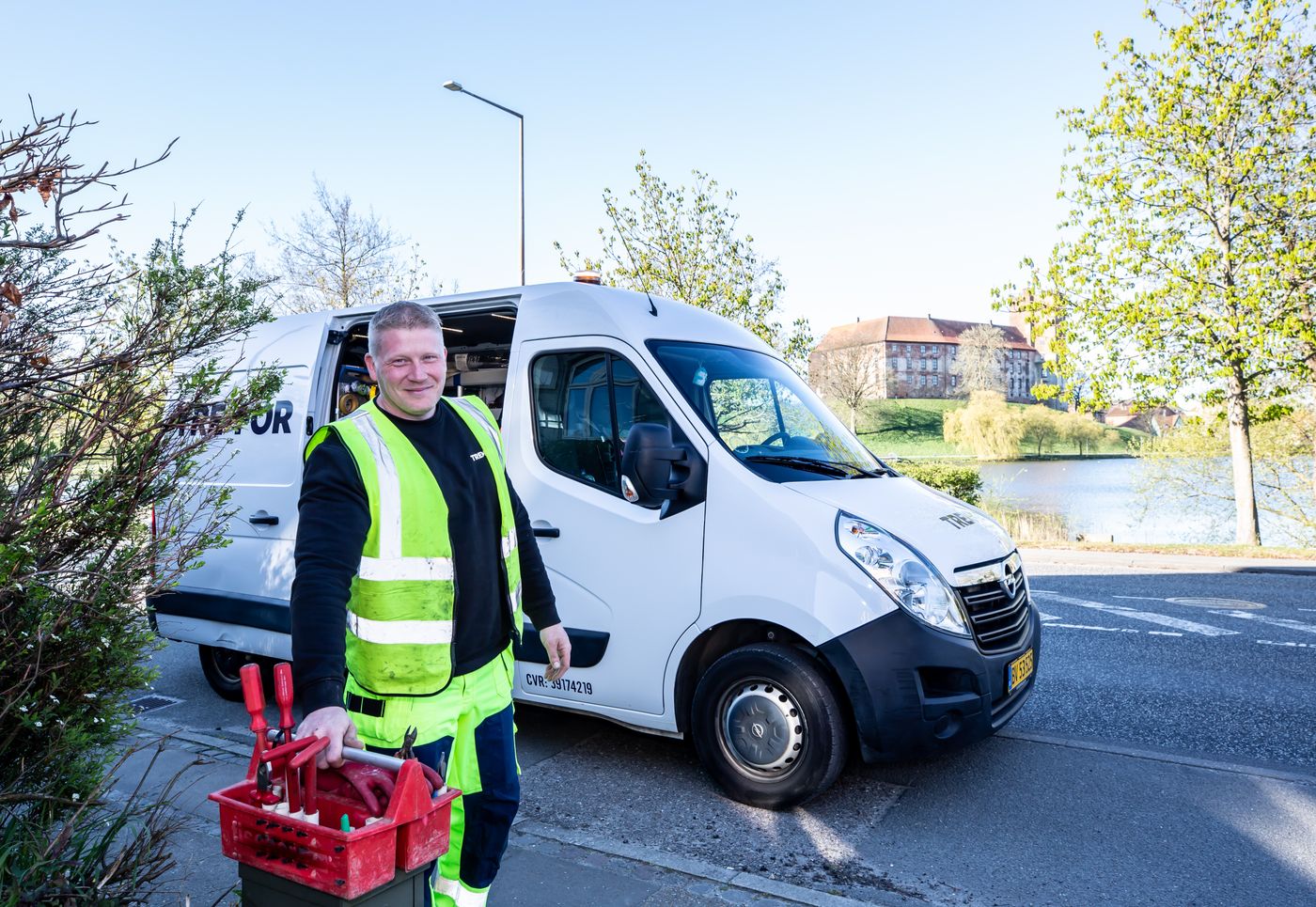 HVAC technician standing beside a service van holding tools, ready for a booked job