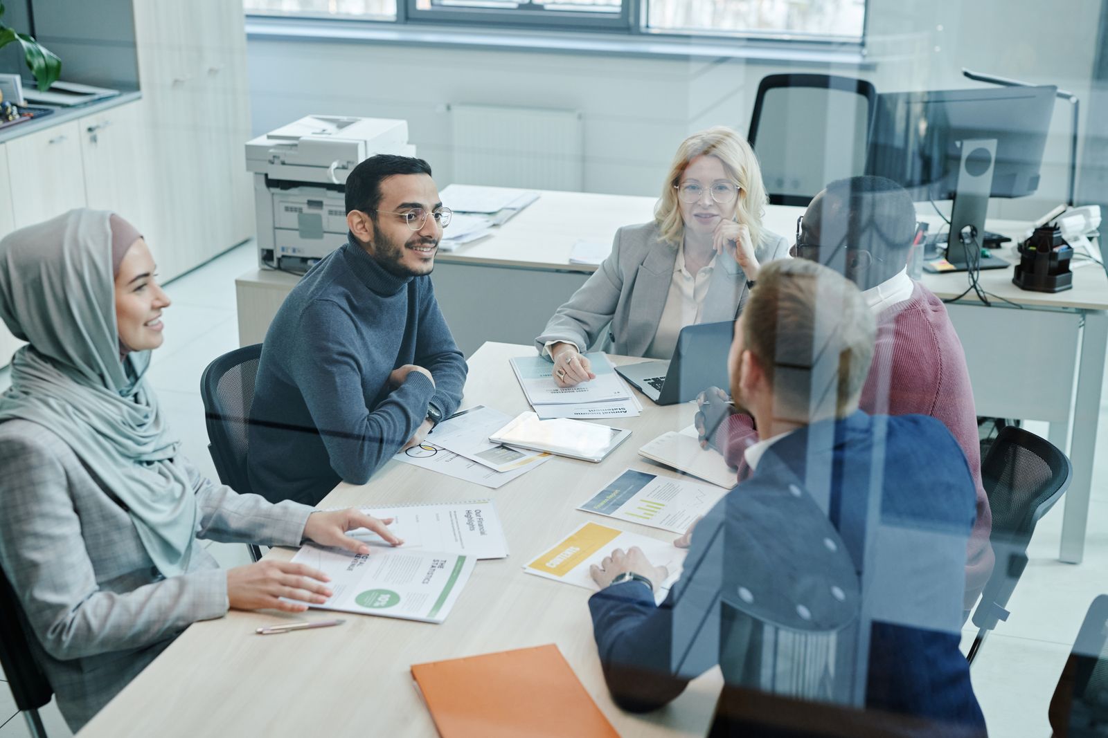 A marketing team reviewing content performance reports together in an office