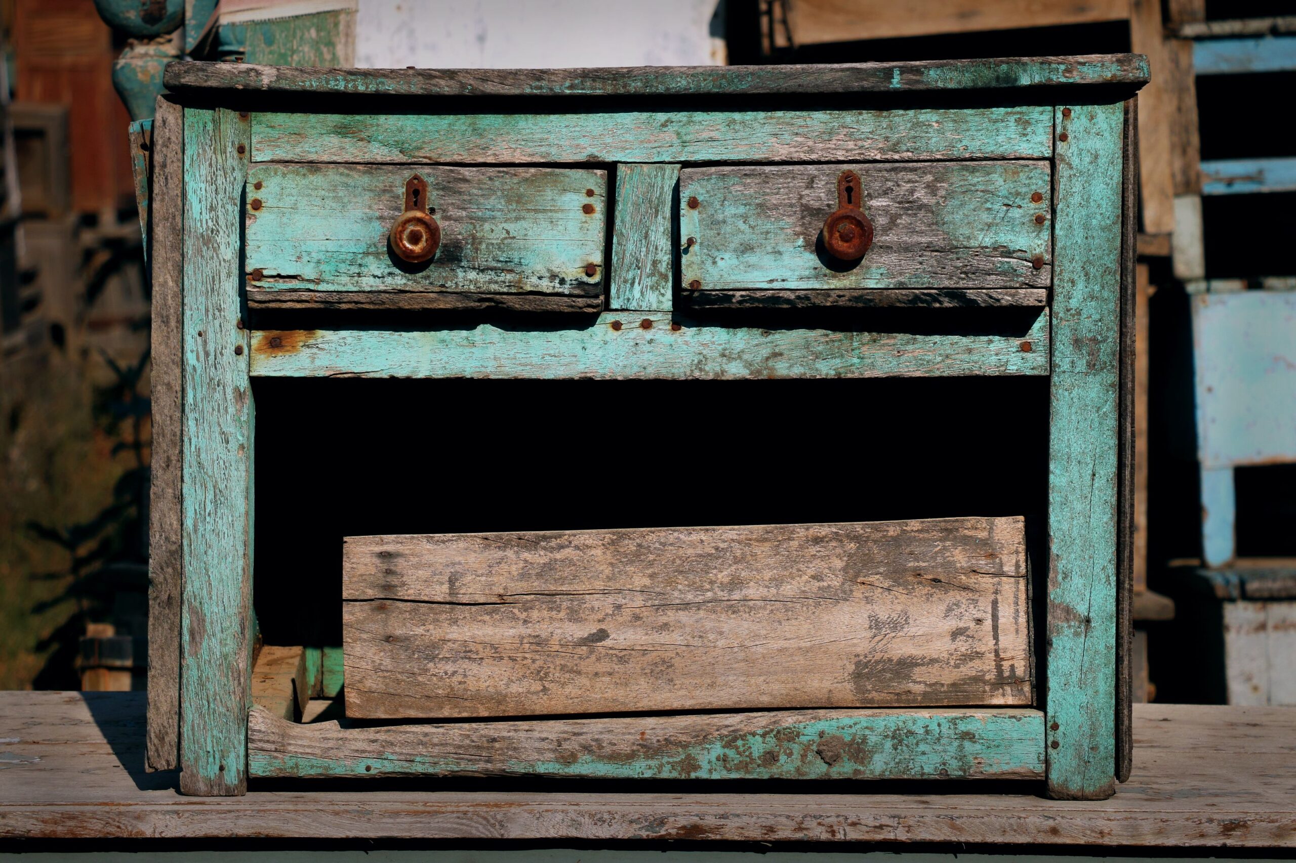 A weathered old dresser left on the curb for junk pickup
