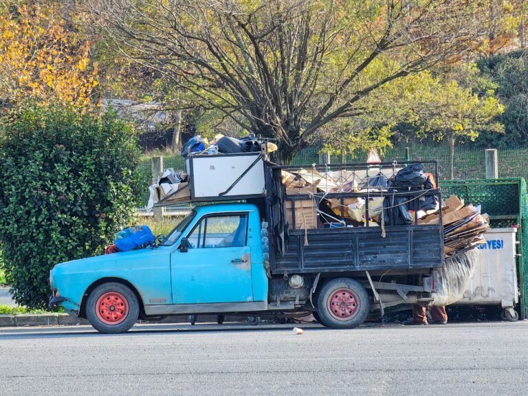 Junk removal company truck loaded with hauled-away furniture and debris