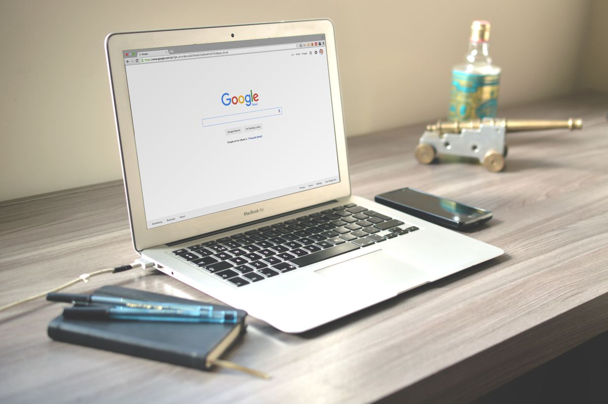 A laptop displaying a Google search page, used for keyword research by a local business