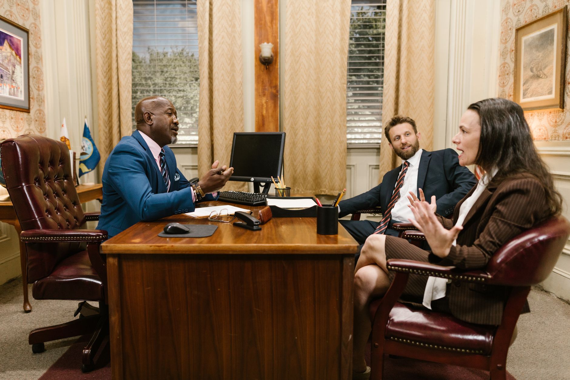 Attorney meeting with a couple in a law office to discuss their injury case