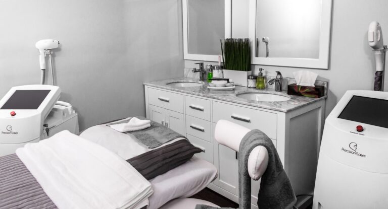 Modern med spa treatment room with laser hair removal machines and marble vanity