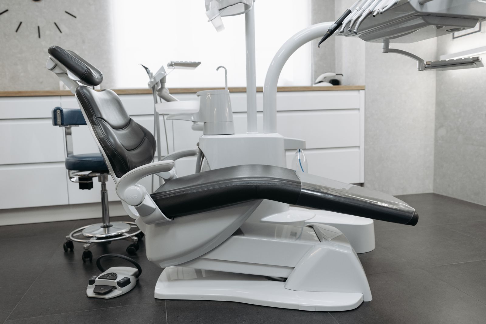 Contemporary dental office with a sleek dental chair and modern equipment